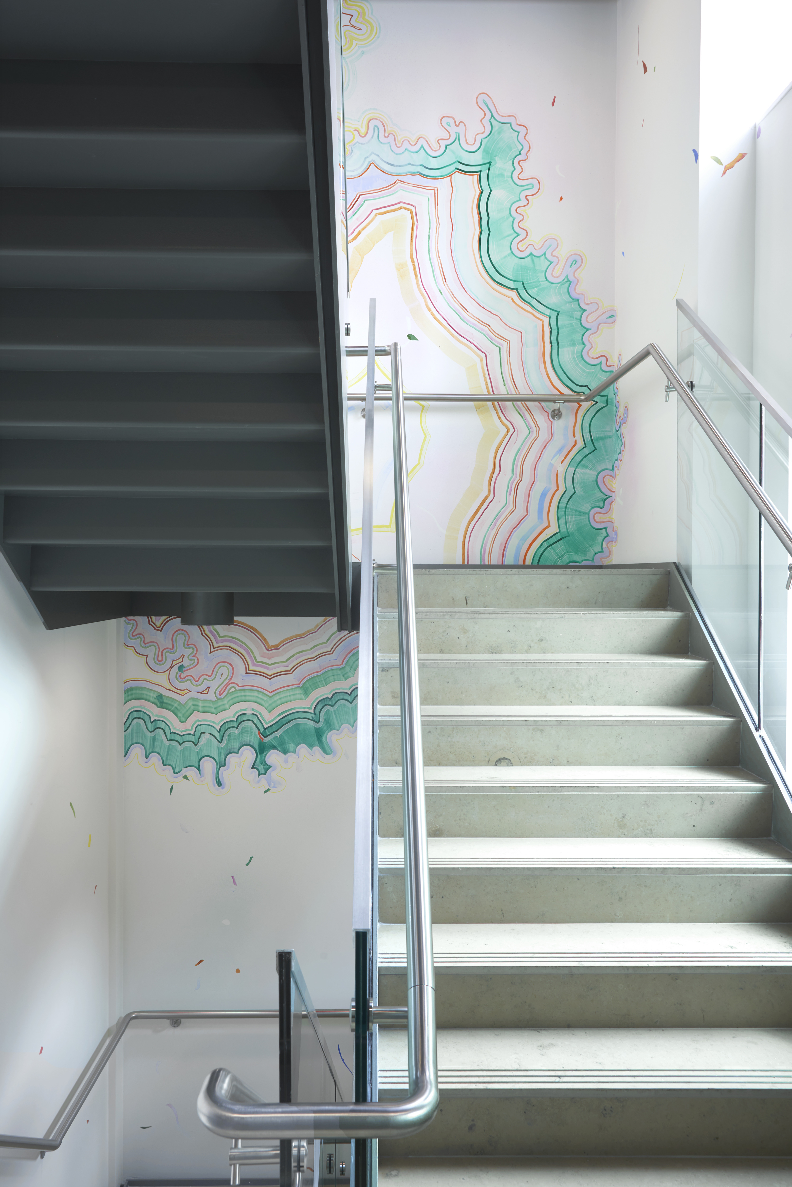 A public commission by artist Claire Hooper. The work is a wall mural situated in a stairwell. It consists of watercolour paint applied in varying colours and following a meticulous pattern that is reminiscent of a stone stratigraphic cross section.