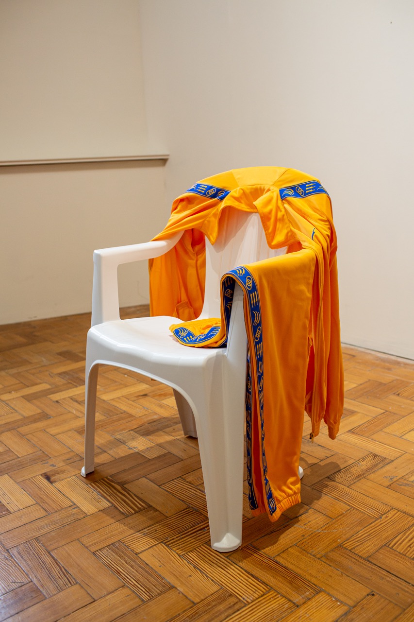 Jasleen Kaur, He Walked Like He Owned Himself, 2018, Embroidered tracksuit and plastic chair © the artist. Image credit: Touchstone Rochdale Arts & Heritage Service